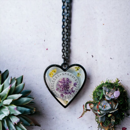 Black Heart necklace with purple and yellow Queen Anne lace flowers and watch part