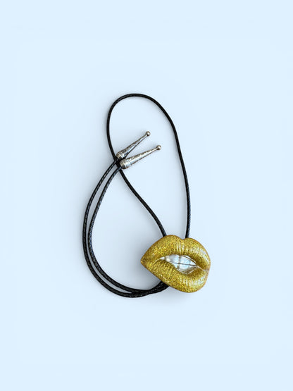 Bolo tie, gold lips and silver teeth