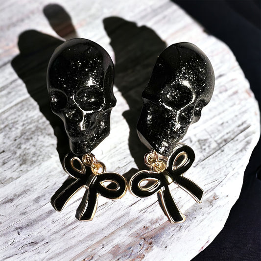 Skull with black bow and gold metal earrings studs