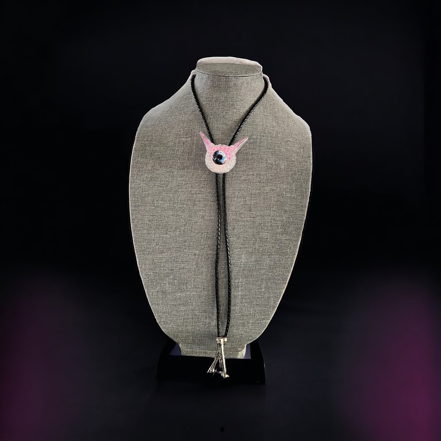 Monster bolo tie in white and pink. Model Pointy.