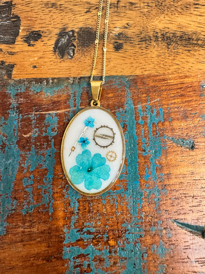 Oval necklace with blue flowers and watch parts