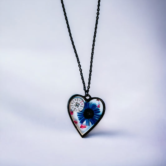 Black Heart necklace with blue chrysanthemum and pink Queen Anne lace flowers and watch parts