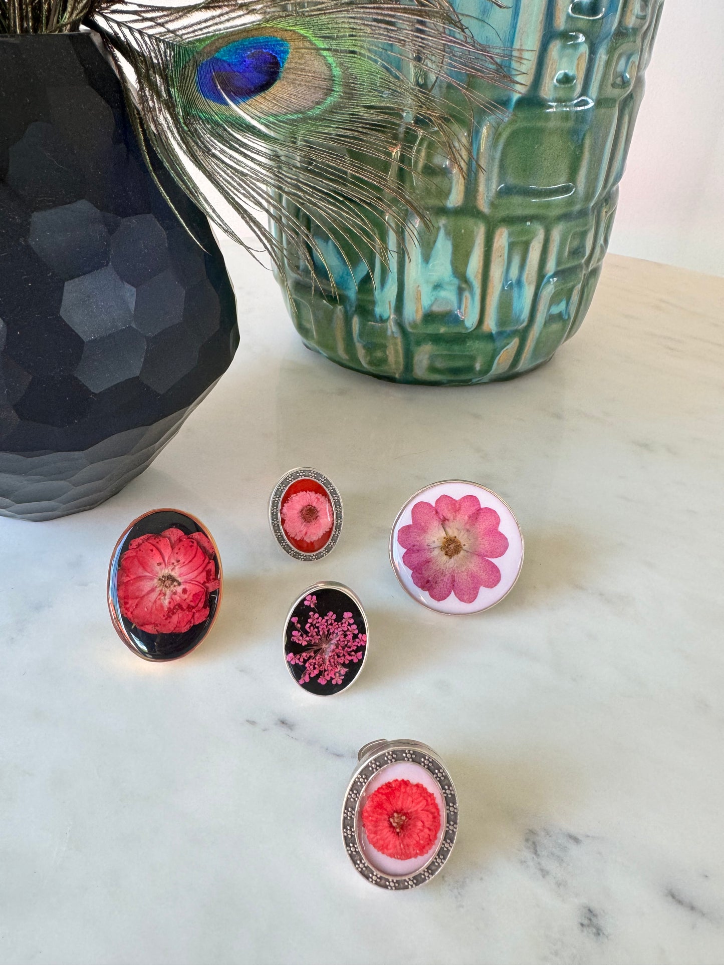 Oval silver plated ring with light pink flower