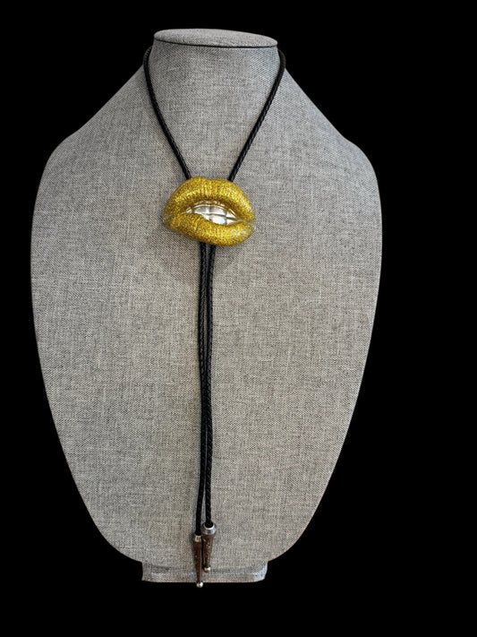 Bolo tie, gold lips and silver teeth
