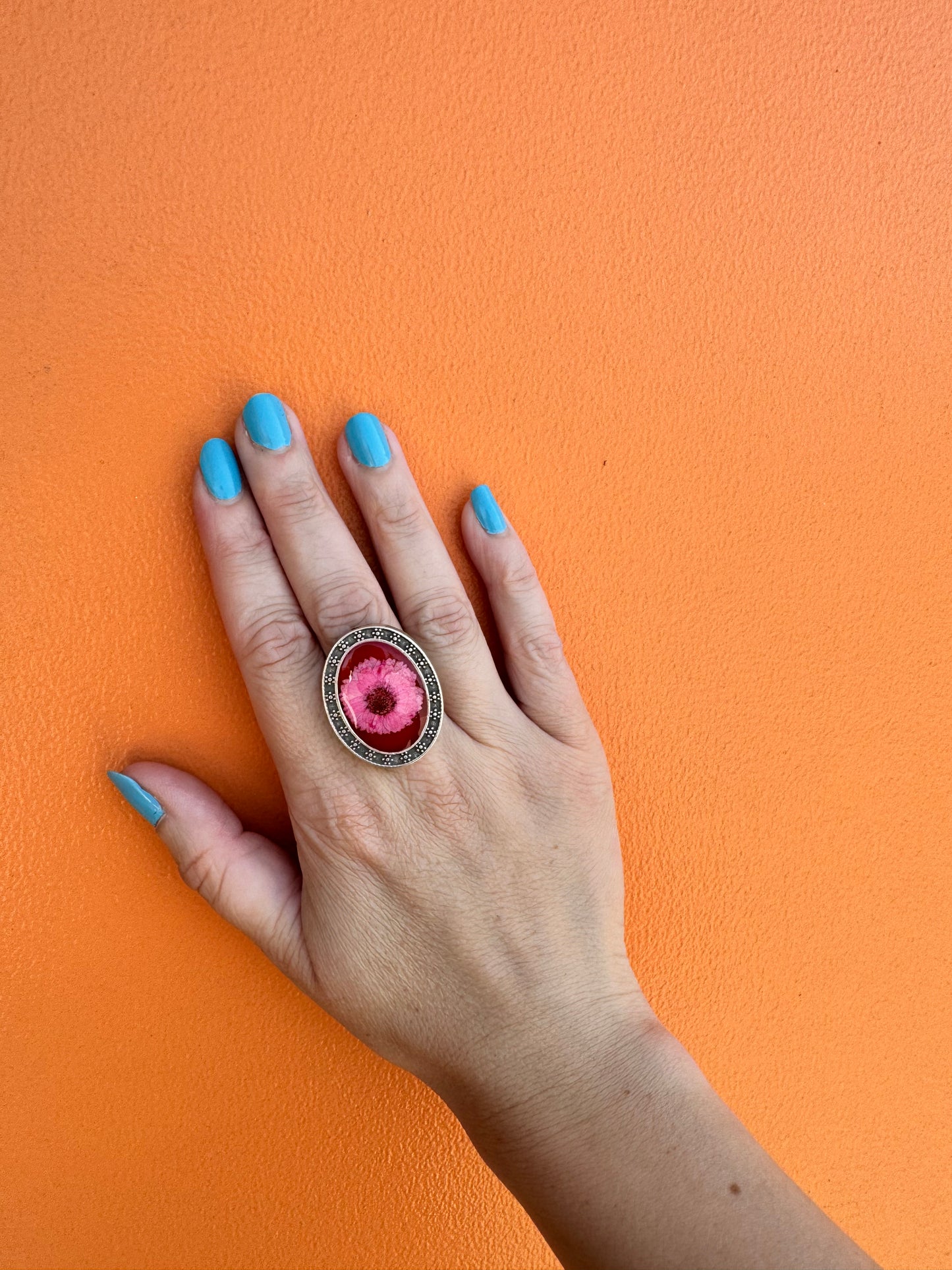 Oval silver plated ring with light pink flower