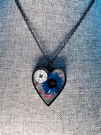 Black Heart necklace with blue chrysanthemum and pink Queen Anne lace flowers and watch parts