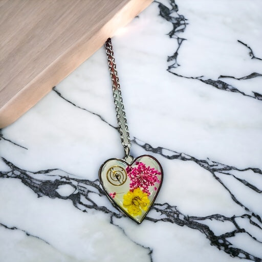 Heart necklace with pink and yellow flowers and watch part