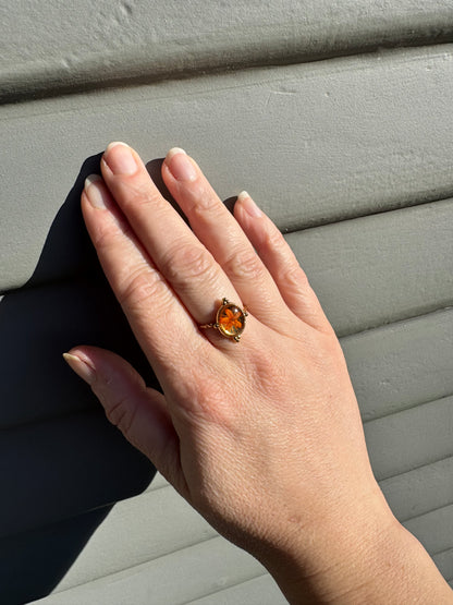 Minimalist gold ring with orange flower