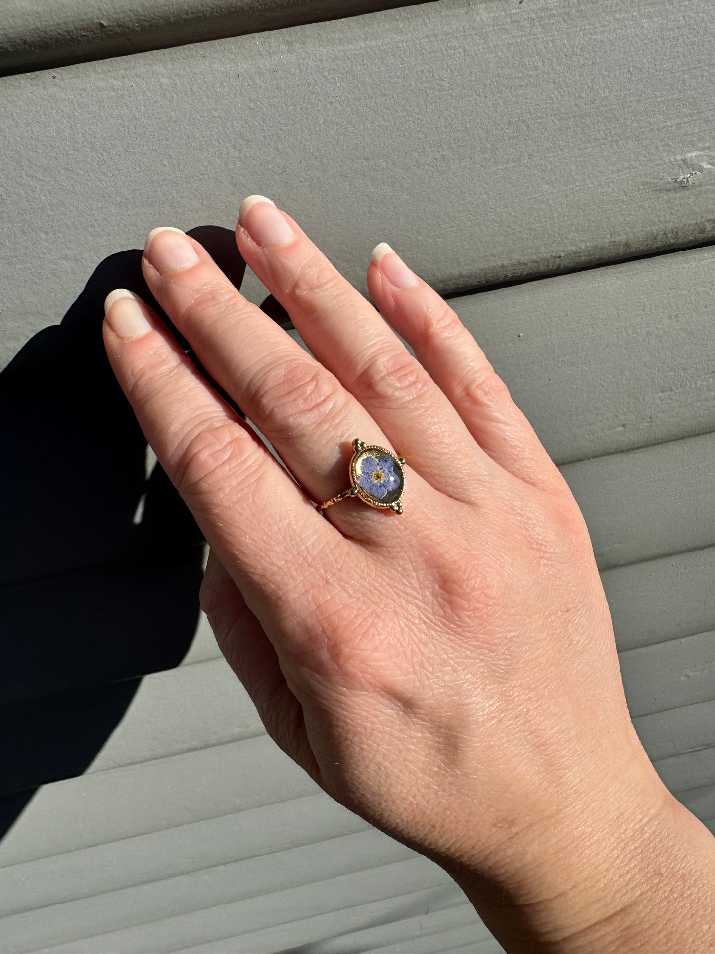 Minimalist gold ring with forget-me-not flower