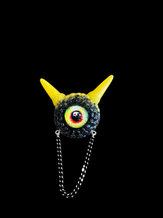 Monster brooch in black and yellow. Model Pointy.