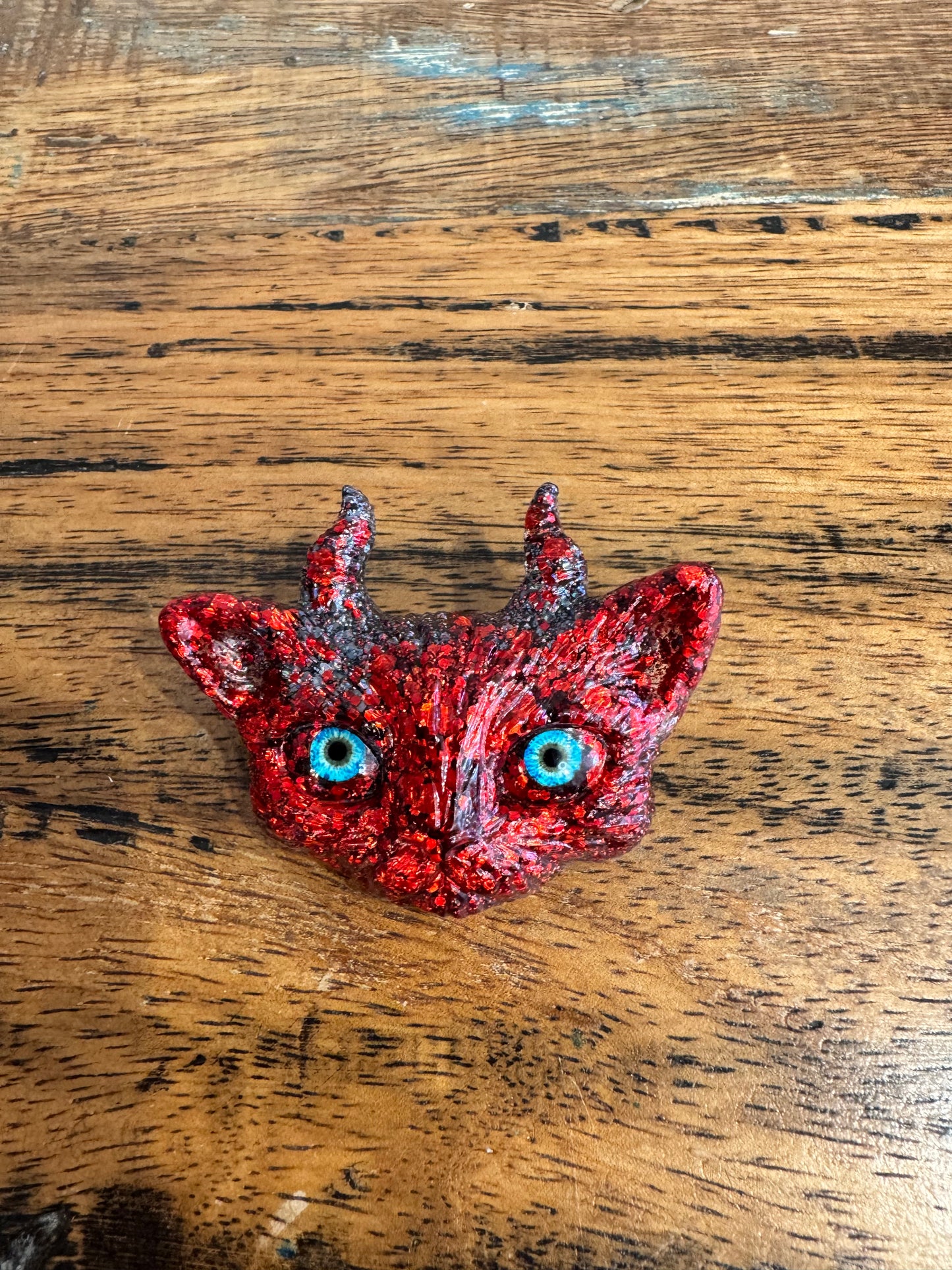 Red cat brooch with horns