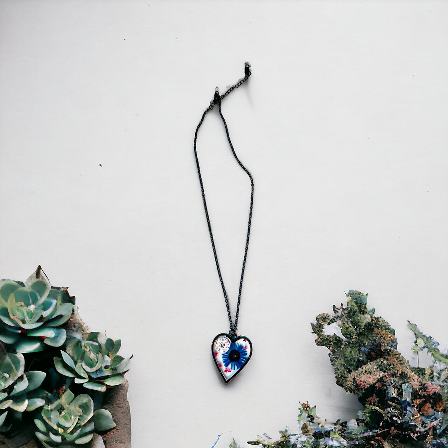 Black Heart necklace with blue chrysanthemum and pink Queen Anne lace flowers and watch parts