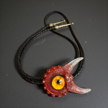 Monster bolo tie in red and silver. Model Vicky.