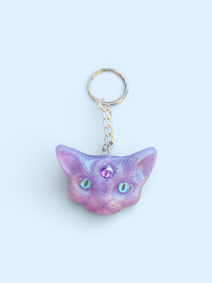 Three eyed cat keychain in purple