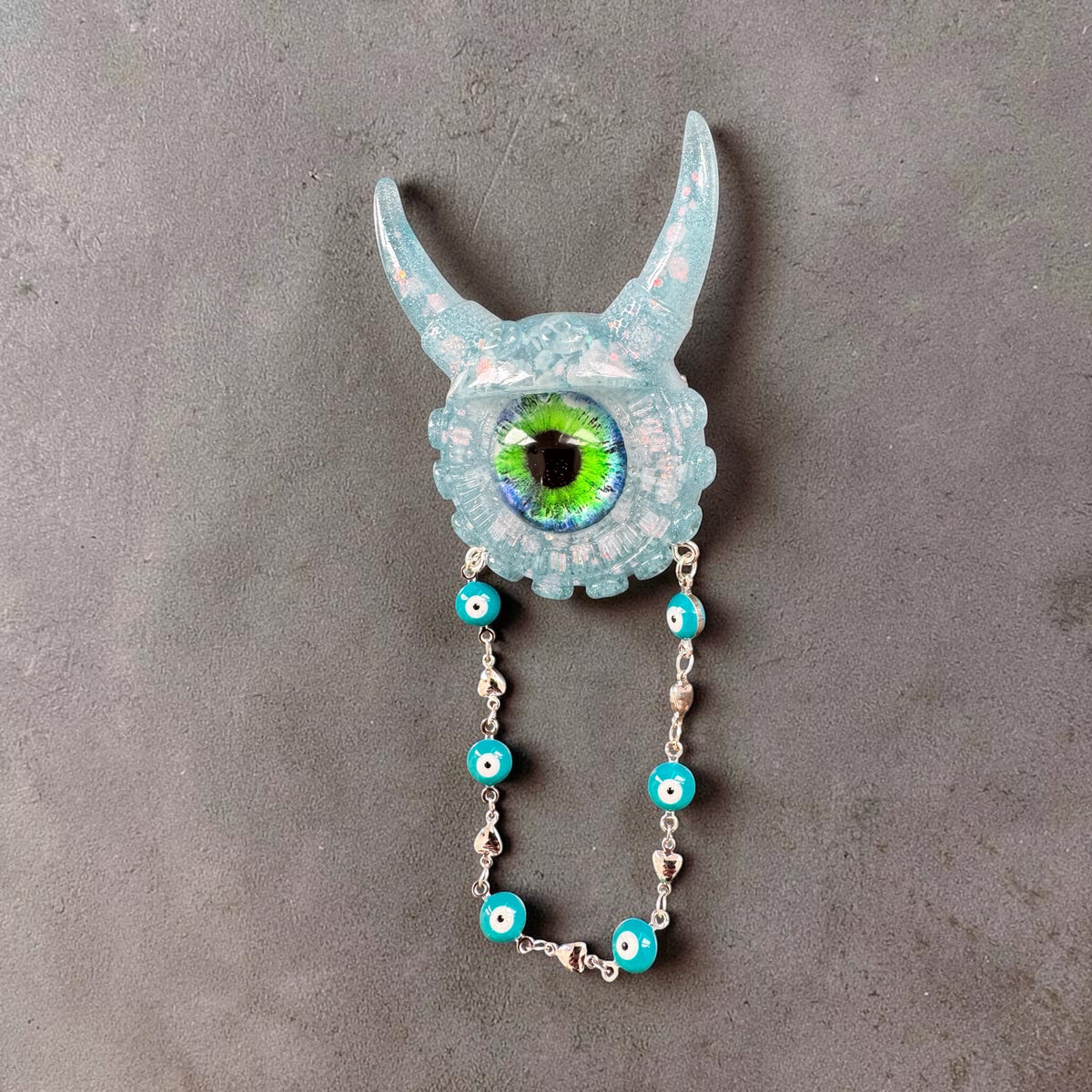 09/05 Monster brooch with chain. Model Vicky.