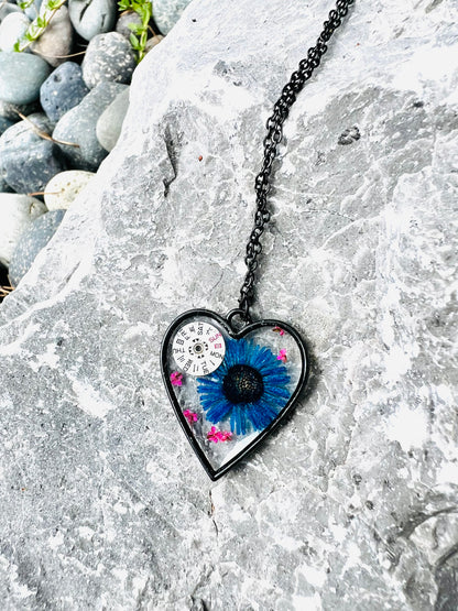 Black Heart necklace with blue chrysanthemum and pink Queen Anne lace flowers and watch parts