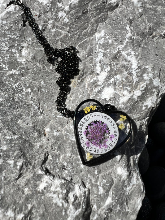 Black Heart necklace with purple and yellow Queen Anne lace flowers and watch part
