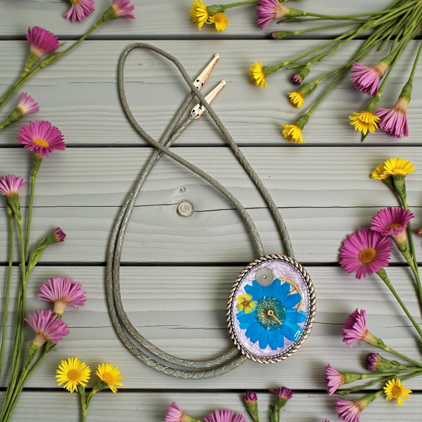 Bolo tie, blue daisy flower and watch gears