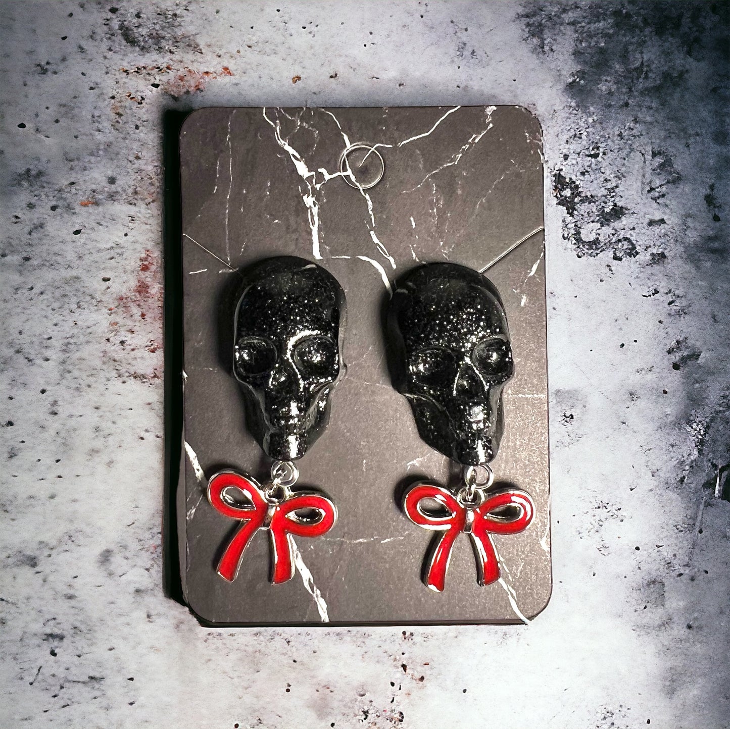 Skull with red bow and silver metal earrings studs