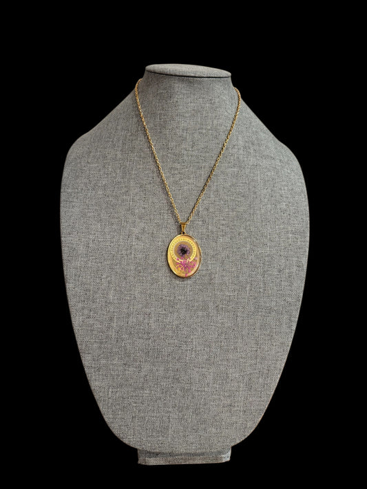 Oval necklace with purple and pink flowers and watch parts