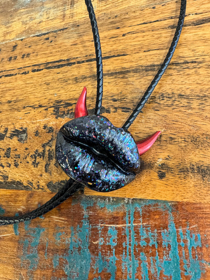 Bolo tie with red horns, shiny black lips
