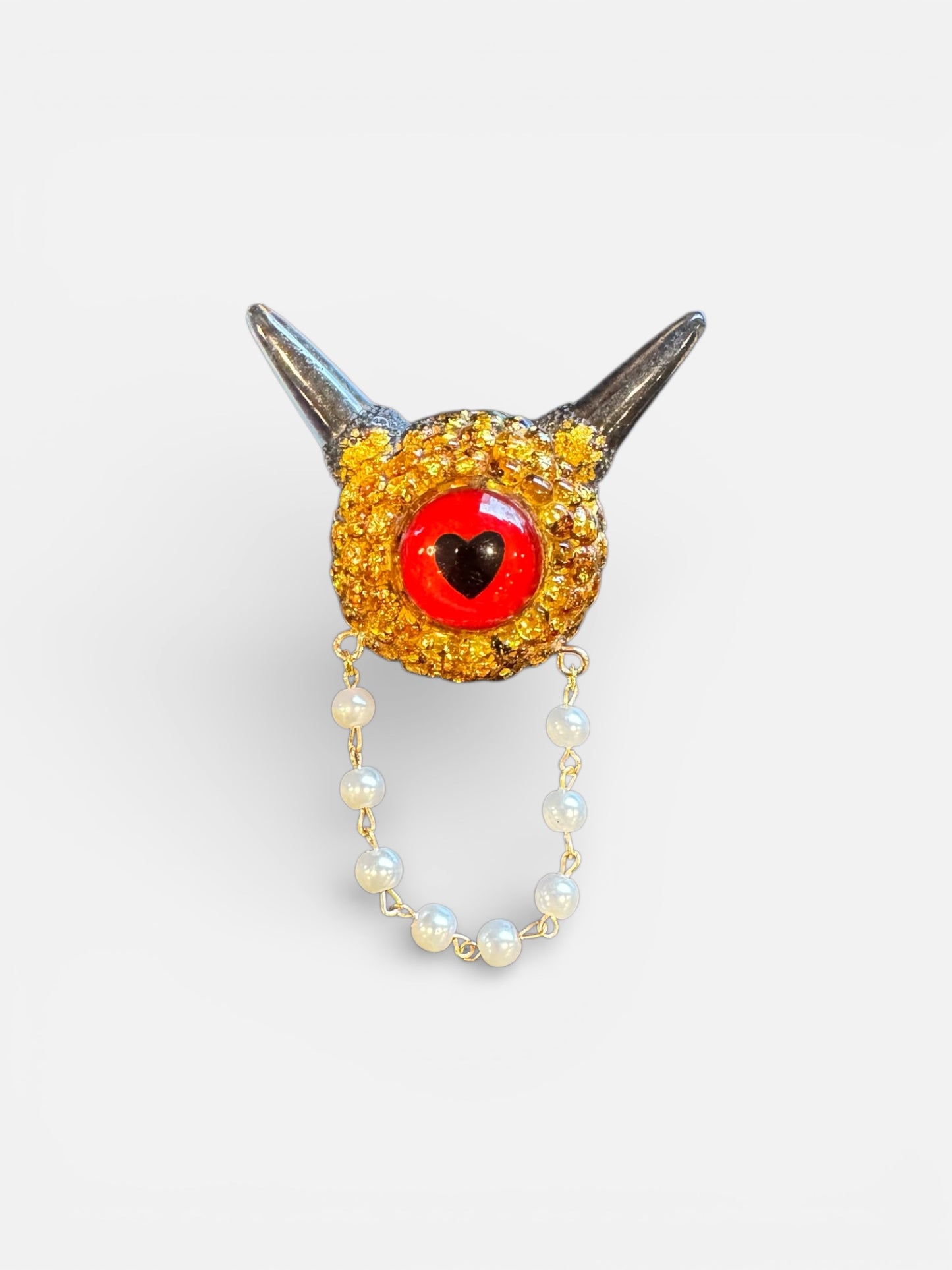 Monster brooch in gold and black. Model Pointy.