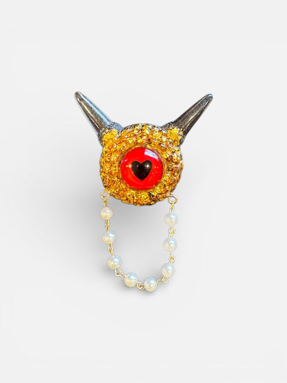 Monster brooch in gold and black. Model Pointy.