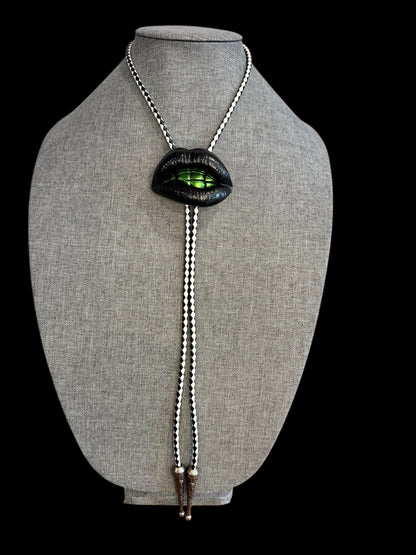 Bolo tie, black lips and green teeth