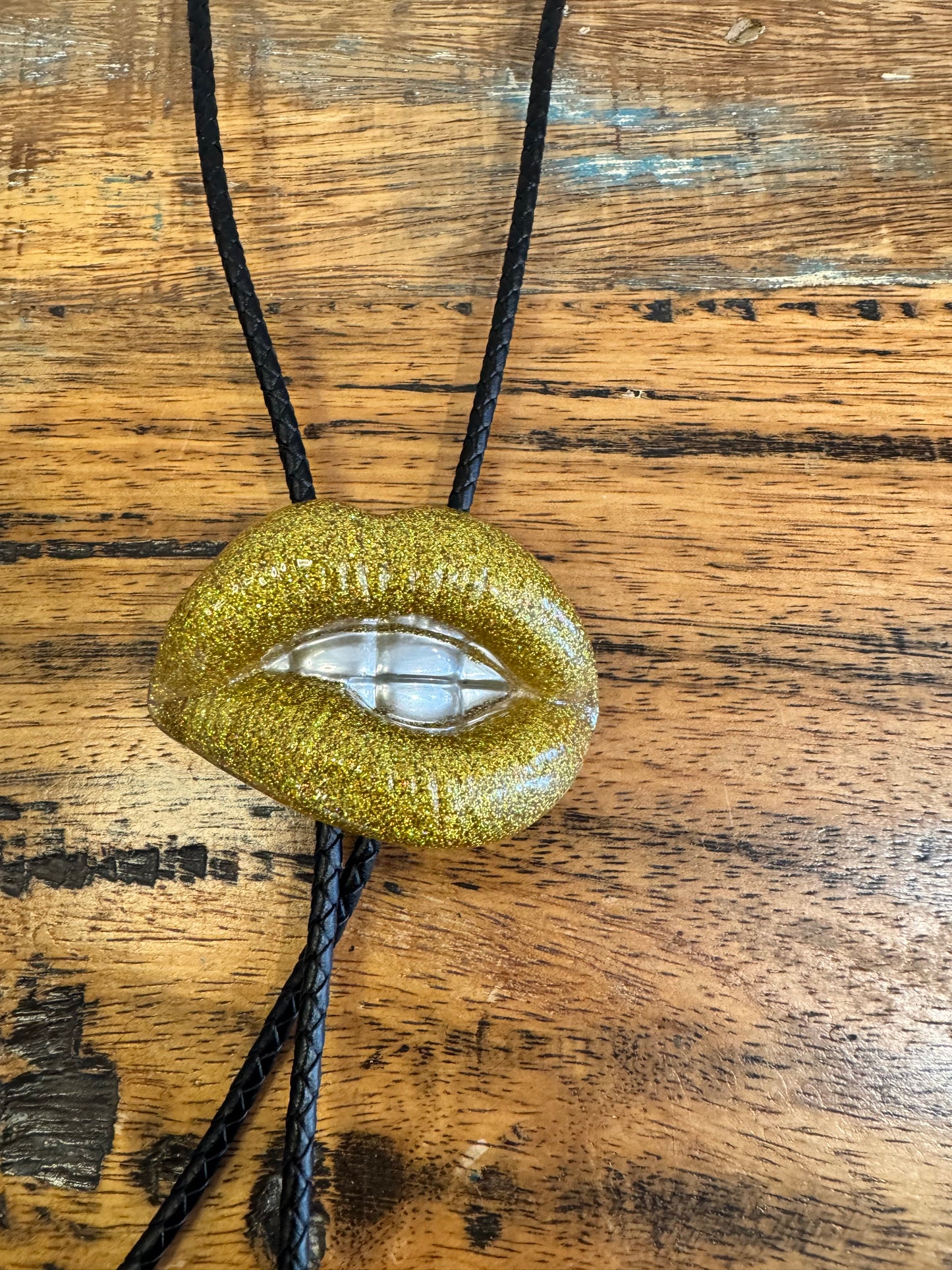 Bolo tie, gold lips and silver teeth