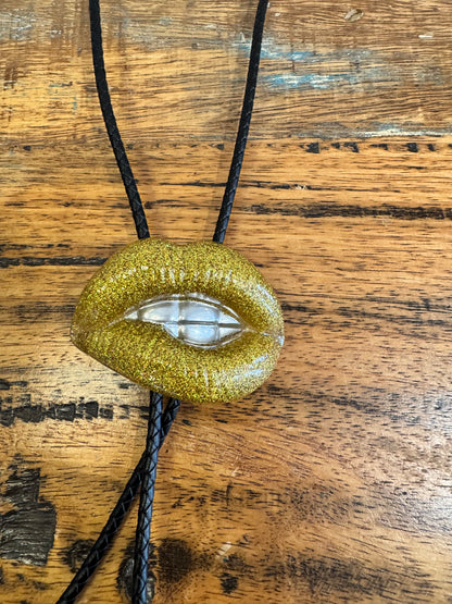 Bolo tie, gold lips and silver teeth