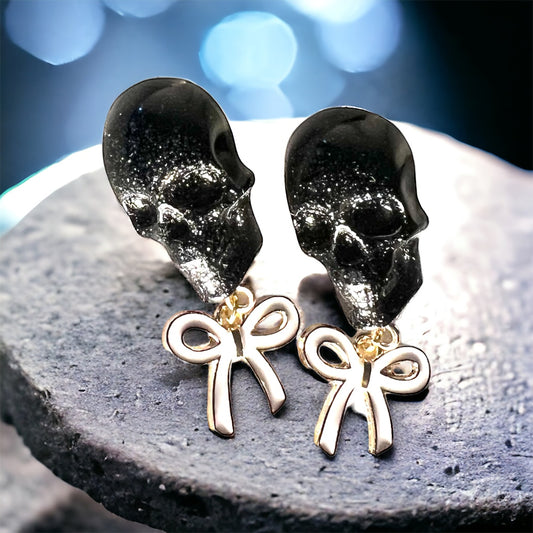 Skull with white bow and gold metal earrings studs