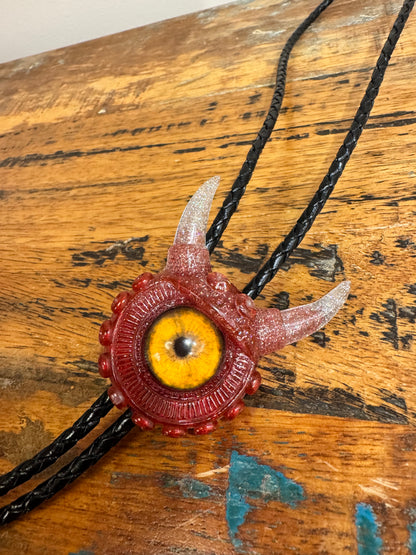 Monster bolo tie in red and silver. Model Vicky.
