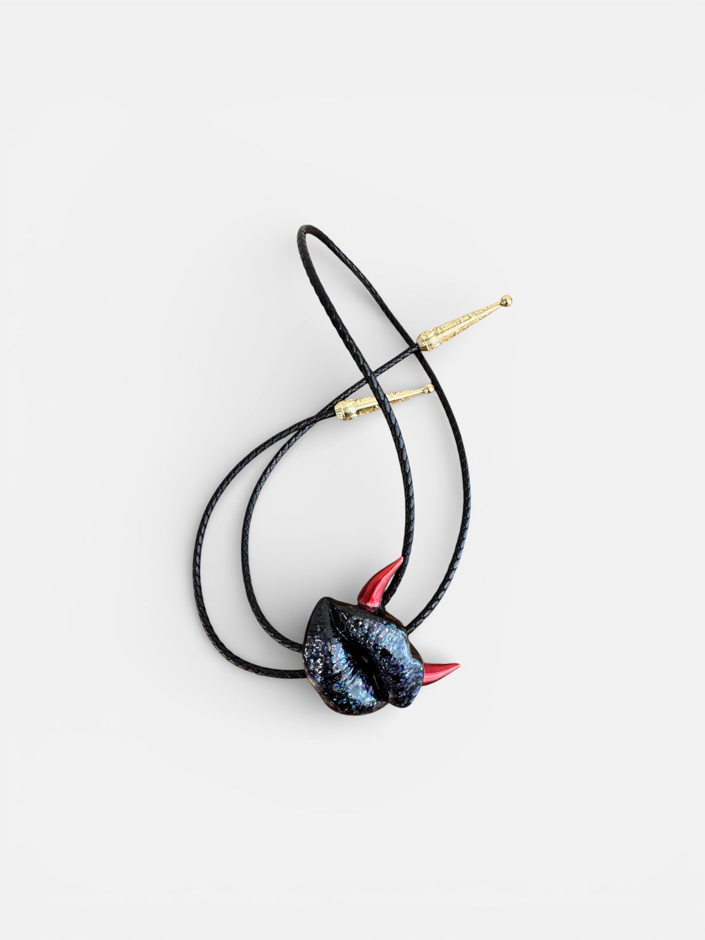 Bolo tie with red horns, shiny black lips