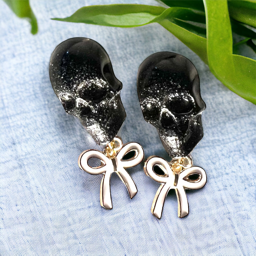 Skull with white bow and gold metal earrings studs