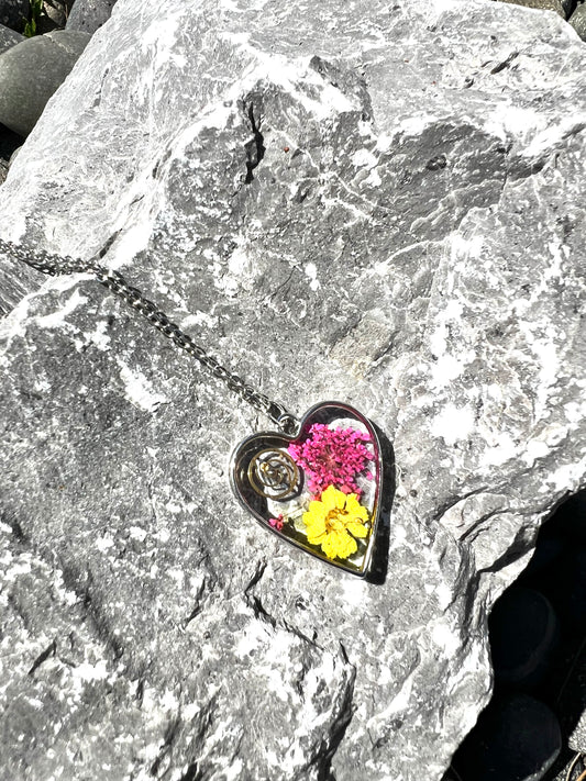 Heart necklace with pink and yellow flowers and watch part