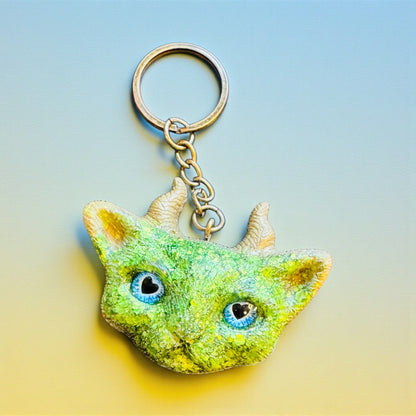 Green cat with gold horns keychain