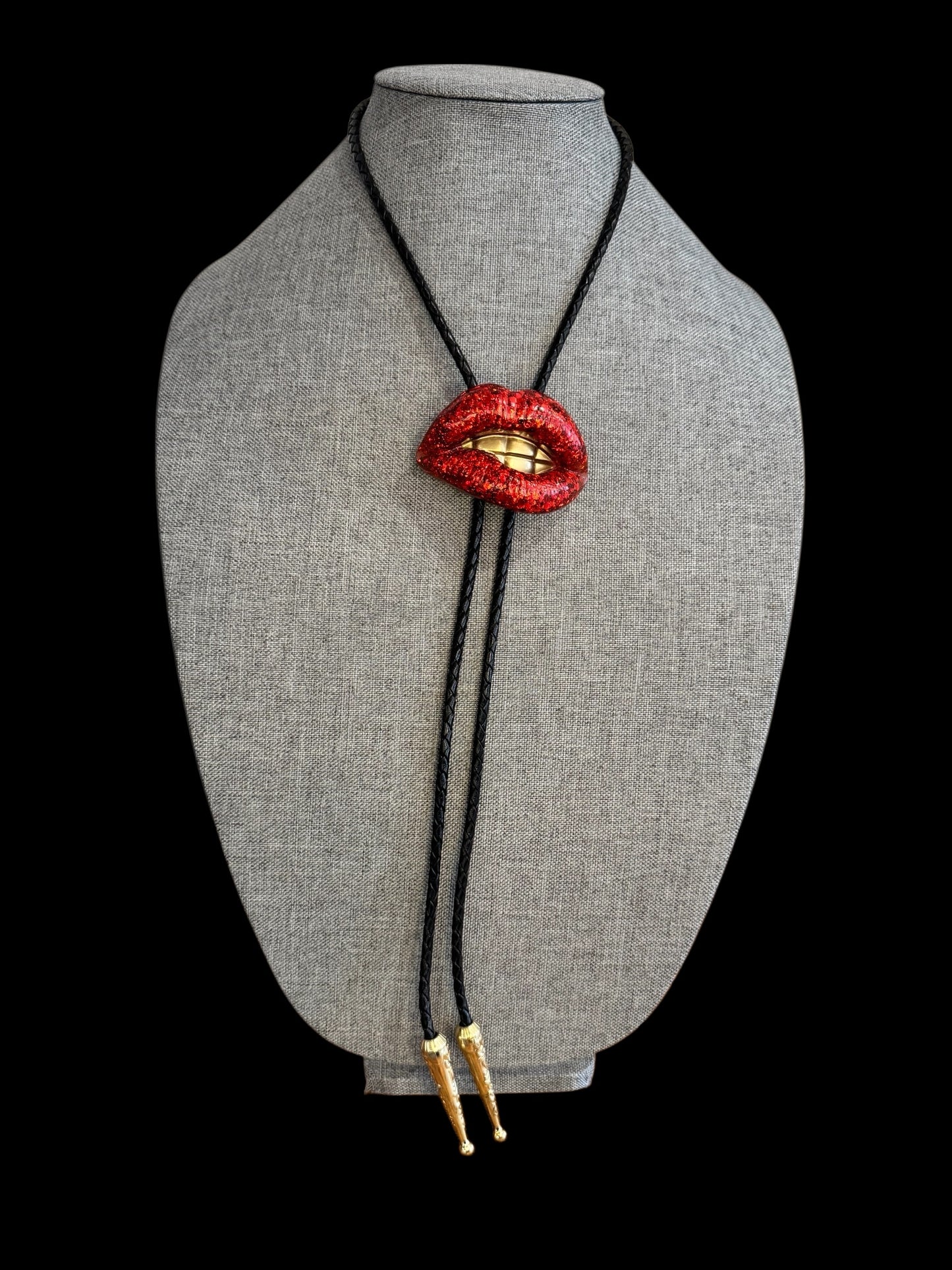 Bolo tie, sparkly red lips with gold teeth