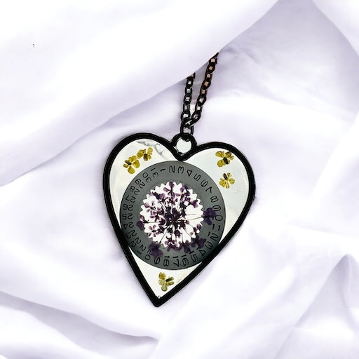 Black Heart necklace with purple and yellow Queen Anne lace flowers and watch part