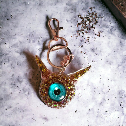 Monster Eye red and gold keychain. Model Pointy.