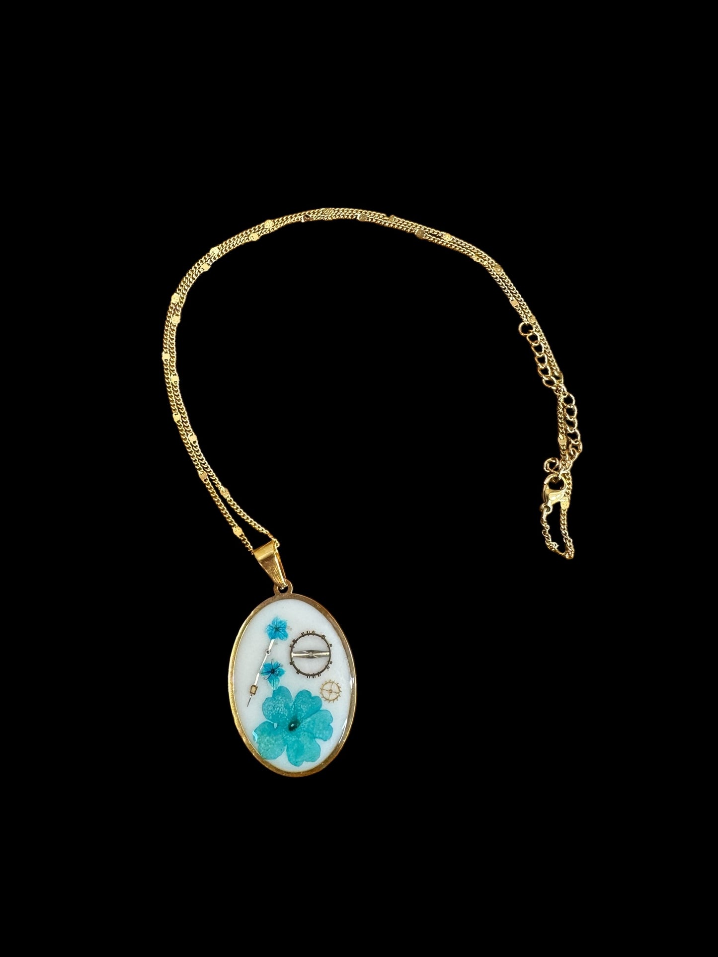 Oval necklace with blue flowers and watch parts