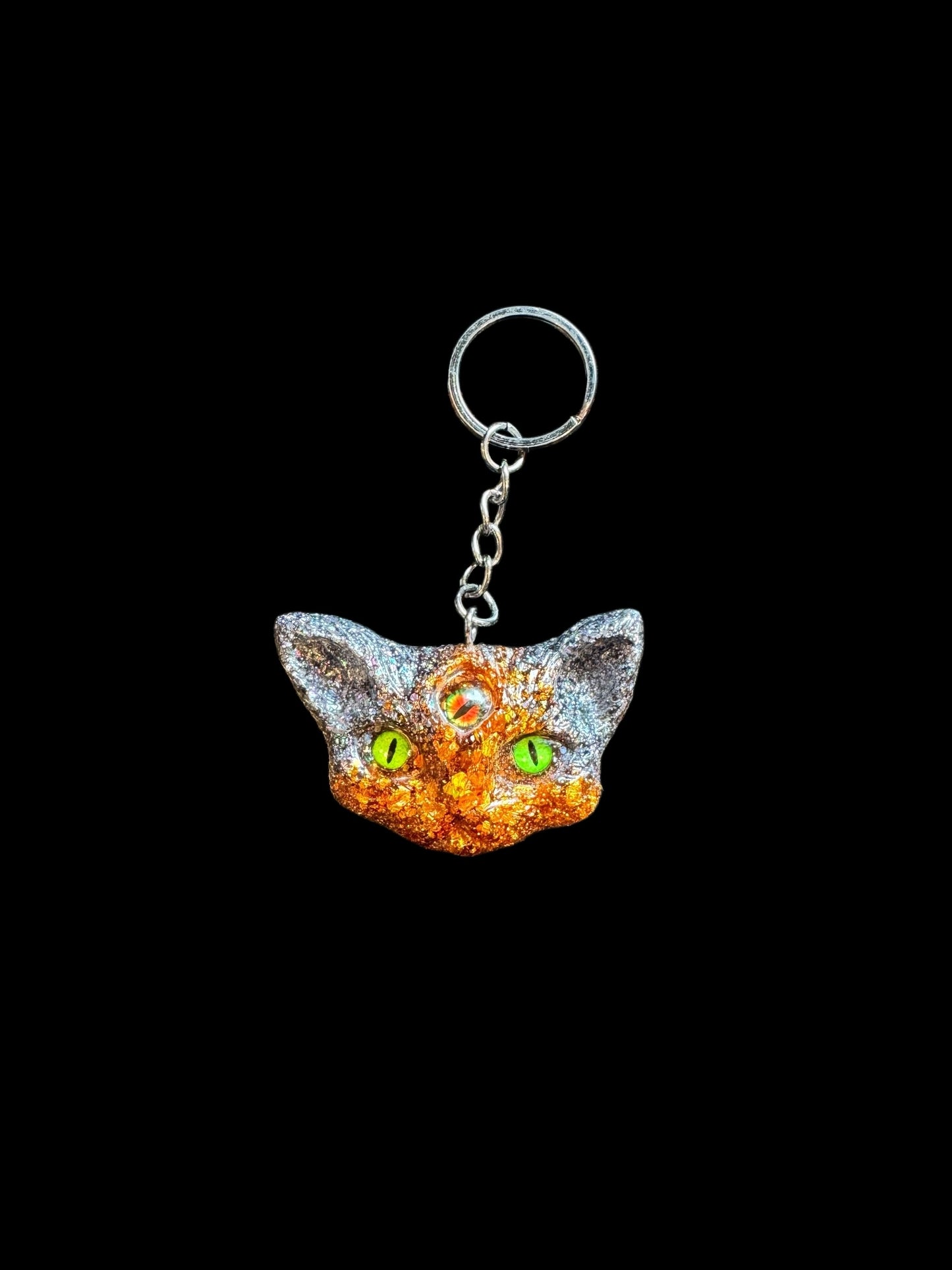 Three eyed cat keychain in orange and black