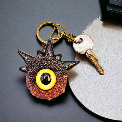 Creepy Monster Eye keychain, black and copper. Model Spiky.