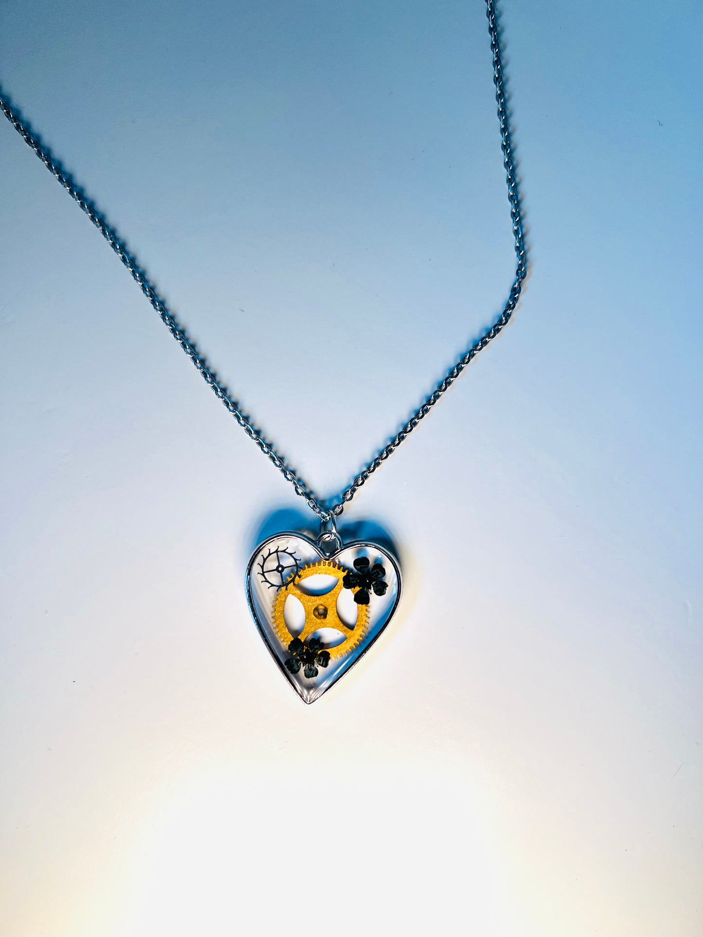 Heart necklace with black flowers and watch parts