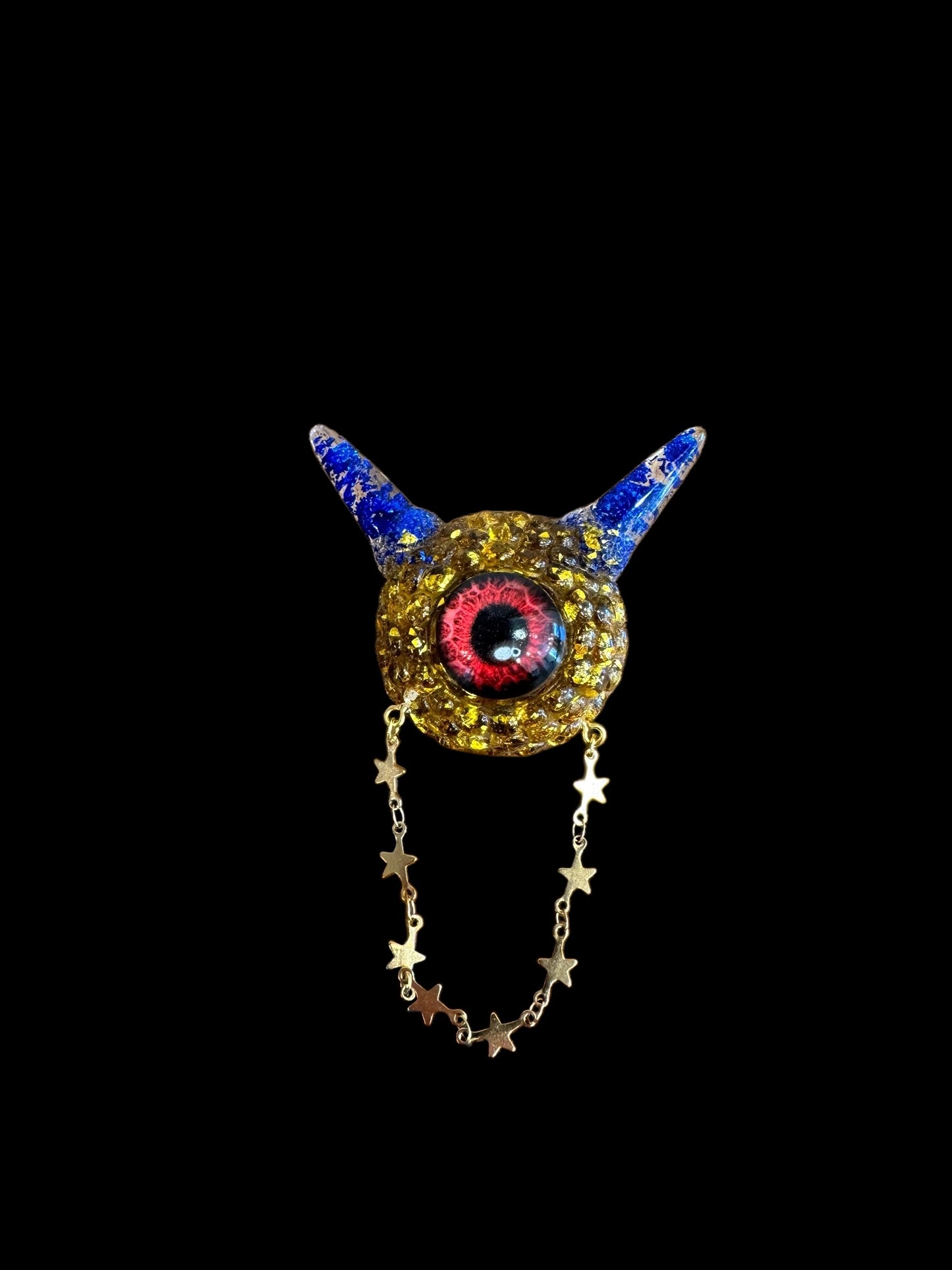 Monster brooch in gold and blue. Model Pointy.