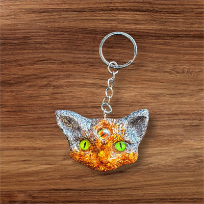 Three eyed cat keychain in orange and black