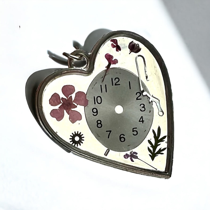 Heart necklace with pink flowers and watch face and gear