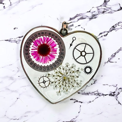 Large heart shape necklace with pink daisy, white Queen Anne lace and watch gear