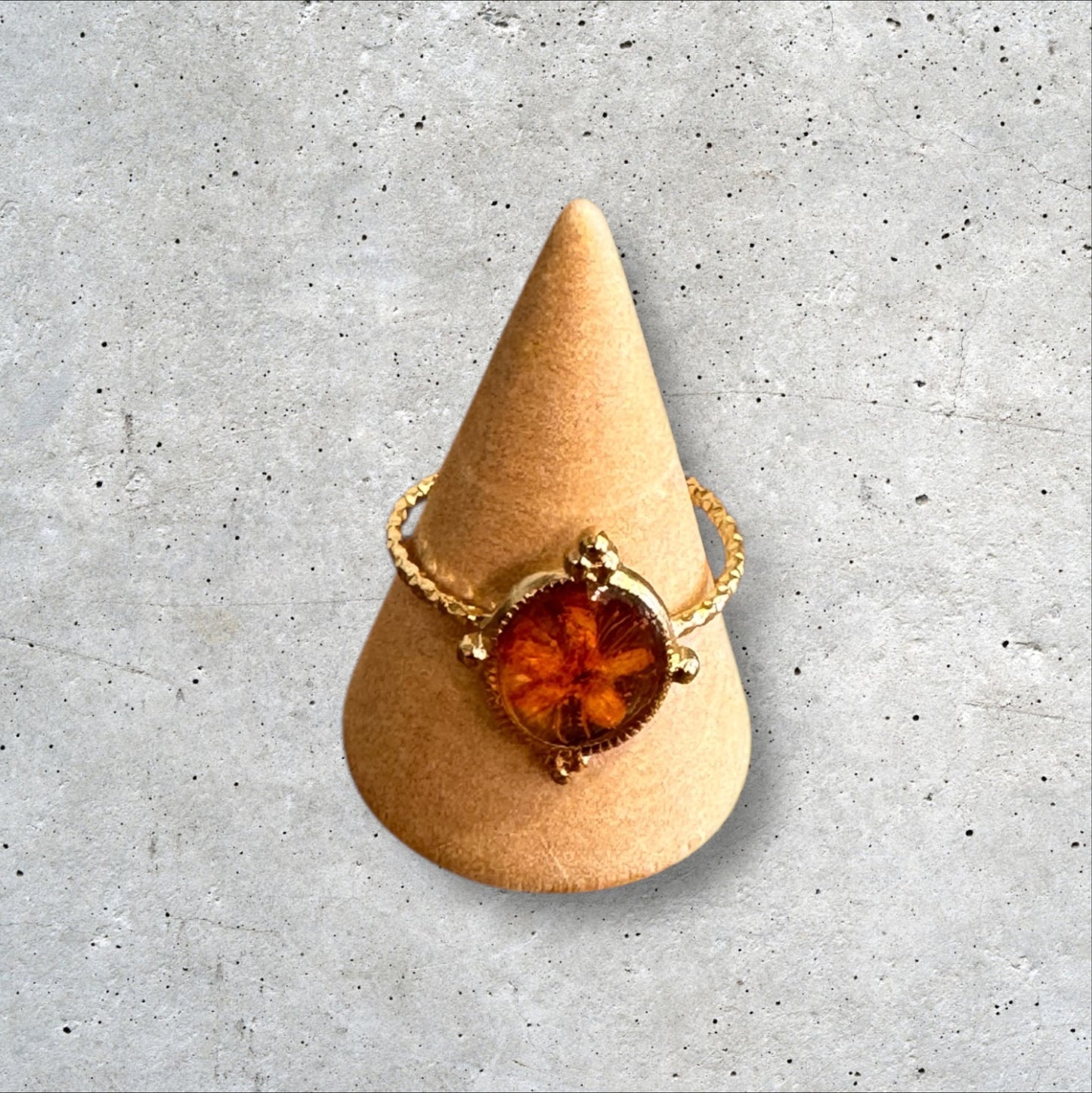 Minimalist gold ring with orange flower