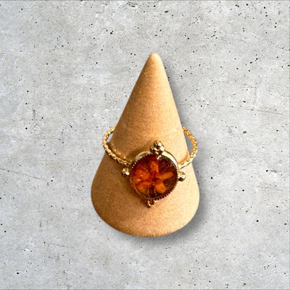 Minimalist gold ring with orange flower