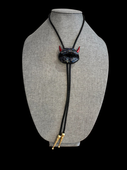Bolo tie with red horns, shiny black lips